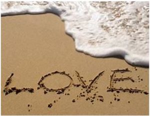 Love written in the sand on a beach