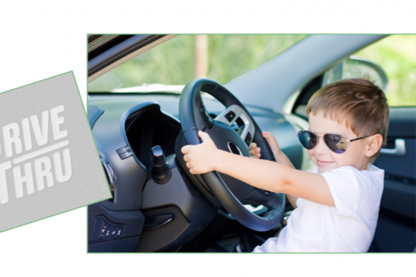Drive thru with kid holding car steering wheel