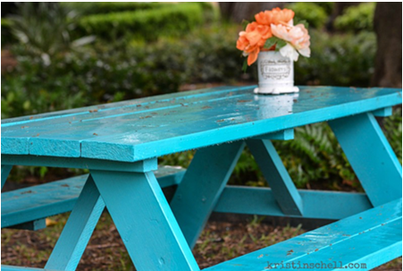 flower vase on a teal picnic table