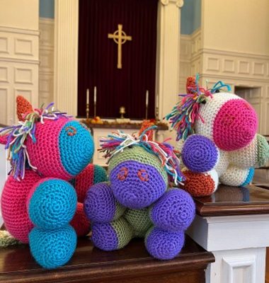 crochet balls in front of a church altar with a cross
