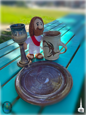 Jesus doll on turquoise picnic table