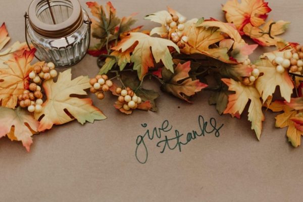 give thanks written next to colorful fall leaves